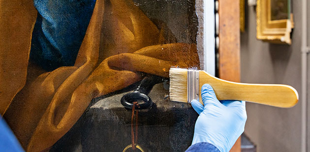CSIRO Brush application of conservation grade resin onto a painting - photo by Selina Ou and Narelle Wilson NGV