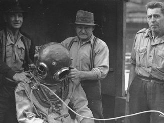 SLM ATW Hard hat diver preparing to enter water from the Maritime Services Board diver's punt - courtesy of NSW State Archives