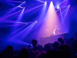Spotlight-on-a-DJ-during-a-concert-photo-by-Antoine-J.-on-Unsplash