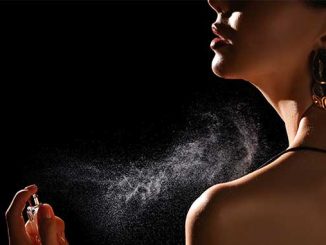 A woman spraying scent on her body