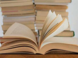 AAR white book on brown wooden table photo by Elisa Calvet B. on Unsplash 
