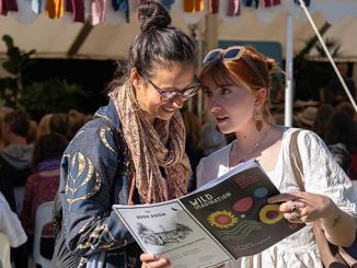 Consulting the program at the 2023 Byron Writers Festival photo by Kurt Petersen