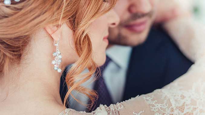 Pearl Earrings A man and woman with pearl earrings in an embrace